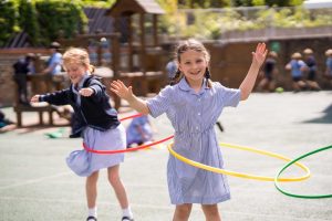 Students playing with their hula hoops in the playground